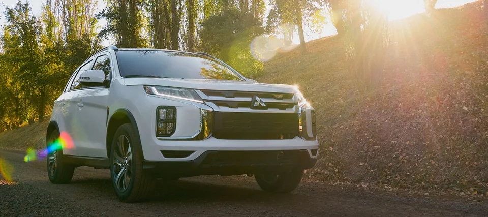 2024 Mitsubishi Outlander Sport SUV driving on the road.