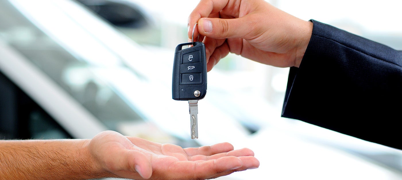 Dealer hands a customer keys
